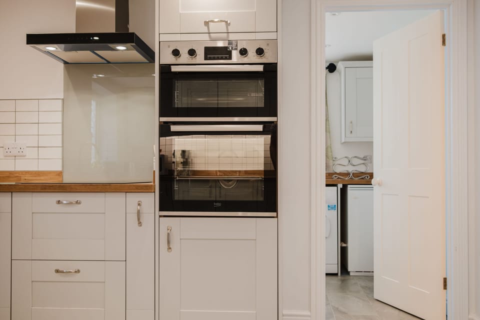 The kitchen leads through to the spacious utility area and ground floor shower room
