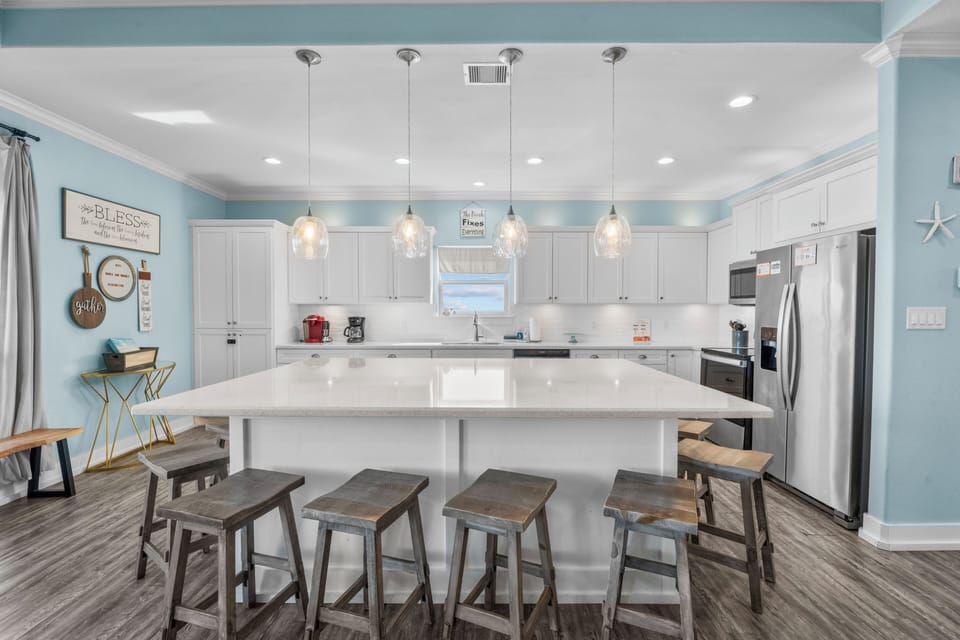 Prepare meals and gather around the spacious kitchen island, featuring generous counter space and bar seating. The open layout makes it easy to cook, dine, and spend time together.