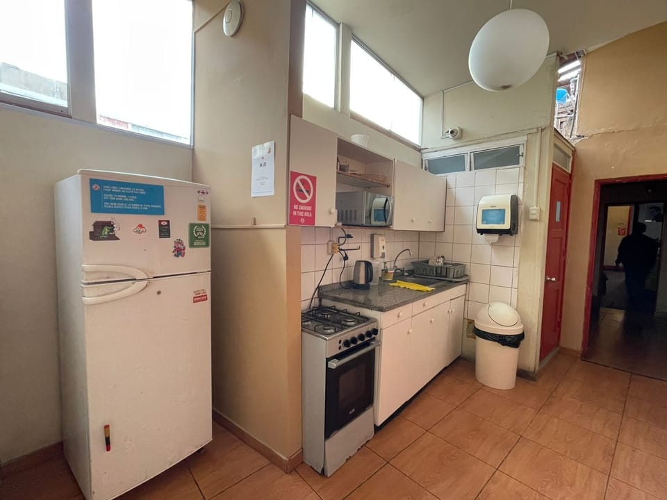 Full-size fridge, microwave, cookware/dishes/utensils, paper towels