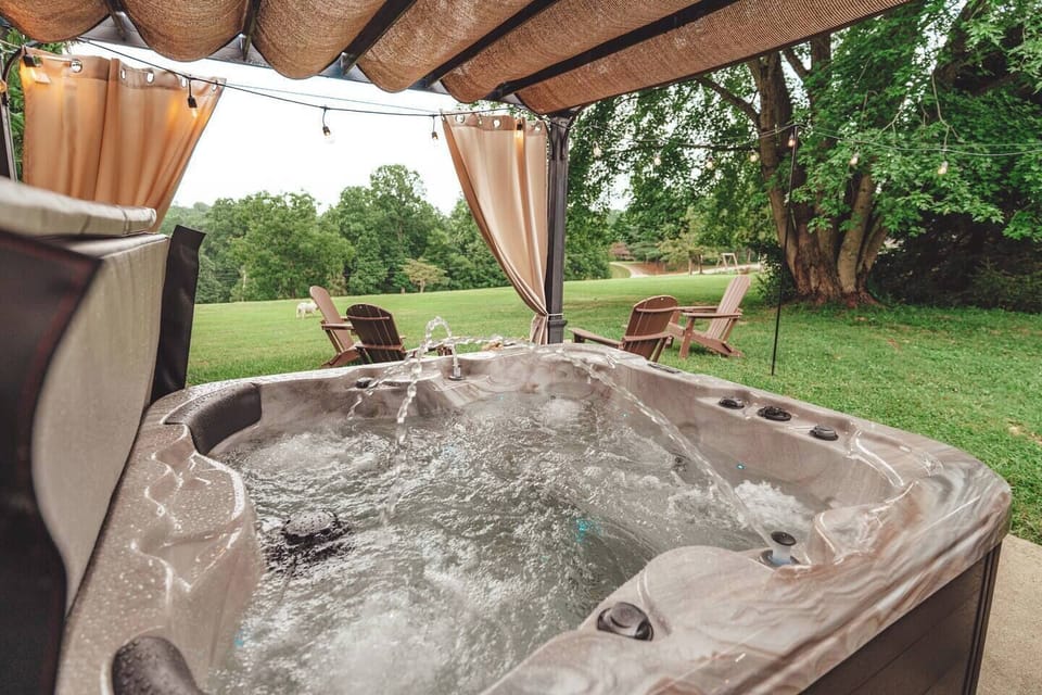 Relax in the covered hot tub with soothing massage jets and serene nature views. Surrounded by mature trees and fresh air, it's the ideal place to recharge any time of day.