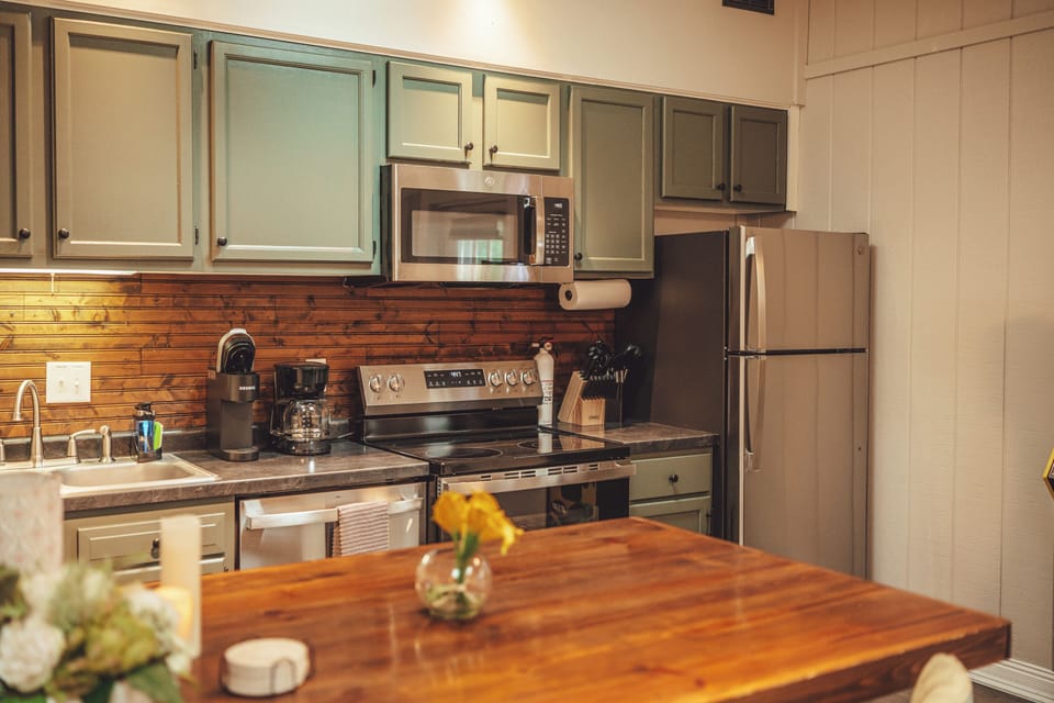 Left apartment:Warm, updated kitchen with stainless appliances and spacious wood island