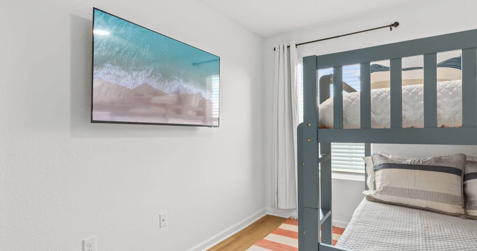 The final bedroom offers a full-over-full bunkbed, twin trundle, & smart TV​