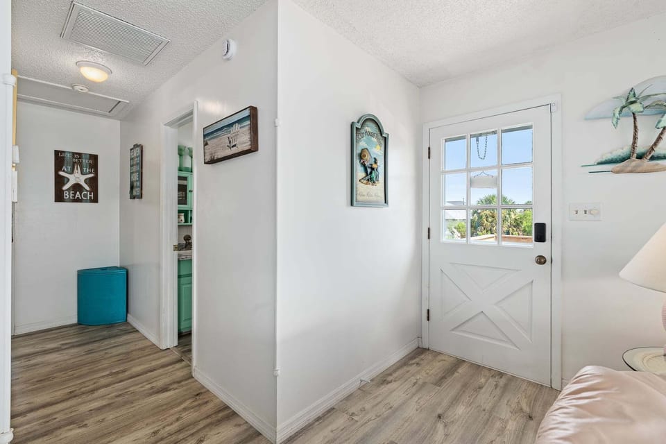 The front entrance welcomes guests with a classic elevated coastal feel