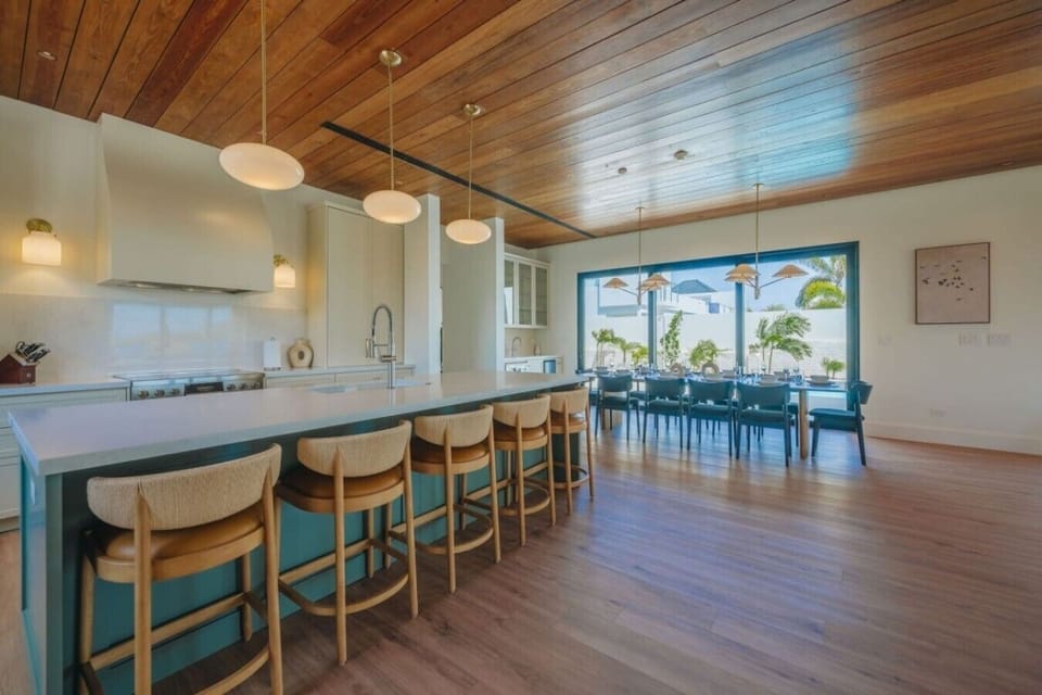 Outfitted with premium appliances, expansive quartz countertops, and a large island with seating for five, the kitchen is as functional as it is beautiful.