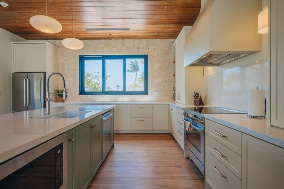 Outfitted with premium appliances, expansive quartz countertops, and a large island with seating for five, the kitchen is as functional as it is beautiful.
