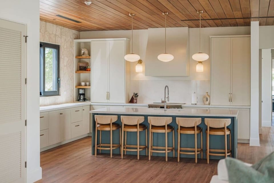 The fully equipped kitchen features a large island, making it easy to prepare meals and gather together.