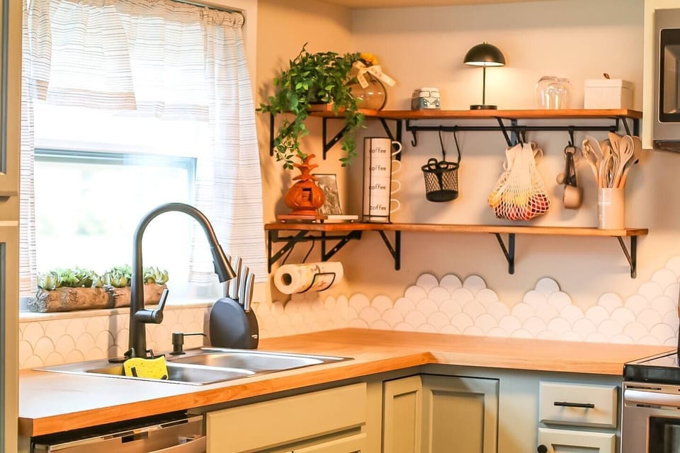 Kitchen fully equipped with, mugs, cups, wine glasses, dishes, measuring cups, pots and pans, baking sheets, silverware, utensils.