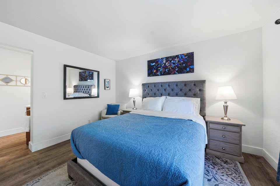Bedroom with queen bed, work station, balcony and ensuite