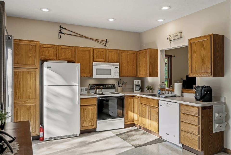 Fully equipped kitchen with stainless steel appliances and ample counter space.