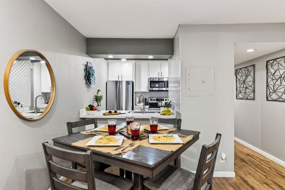 Modern kitchen and dining space with a wooden dining set and updated finishes.