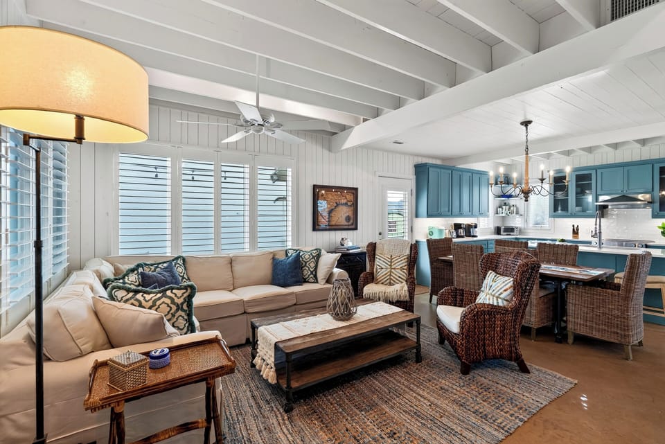 Open living room under vaulted, beamed ceilings.