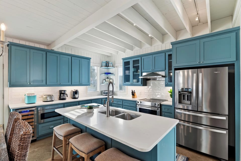 Kitchen island with double sink and bar seating.