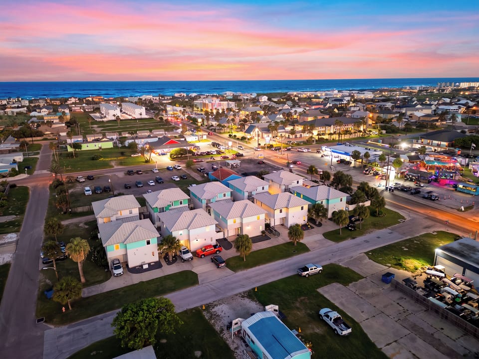 Aerial view of the colorful coastal community at sunset.