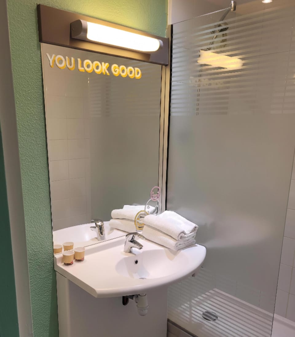 Shower, eco-friendly toiletries, towels, toilet paper