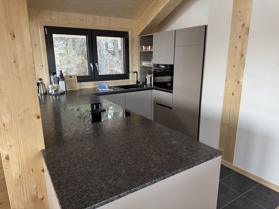 Kitchen, Flooring, Countertop, Cabinetry, Granite, Natural Material, Kitchen Appliance, Major Appliance, Wood Stain, Home Appliance