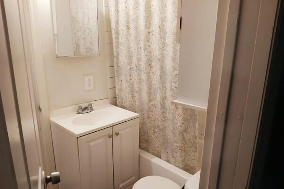 Fully equipped bathroom with modern vanity and clean finishes.