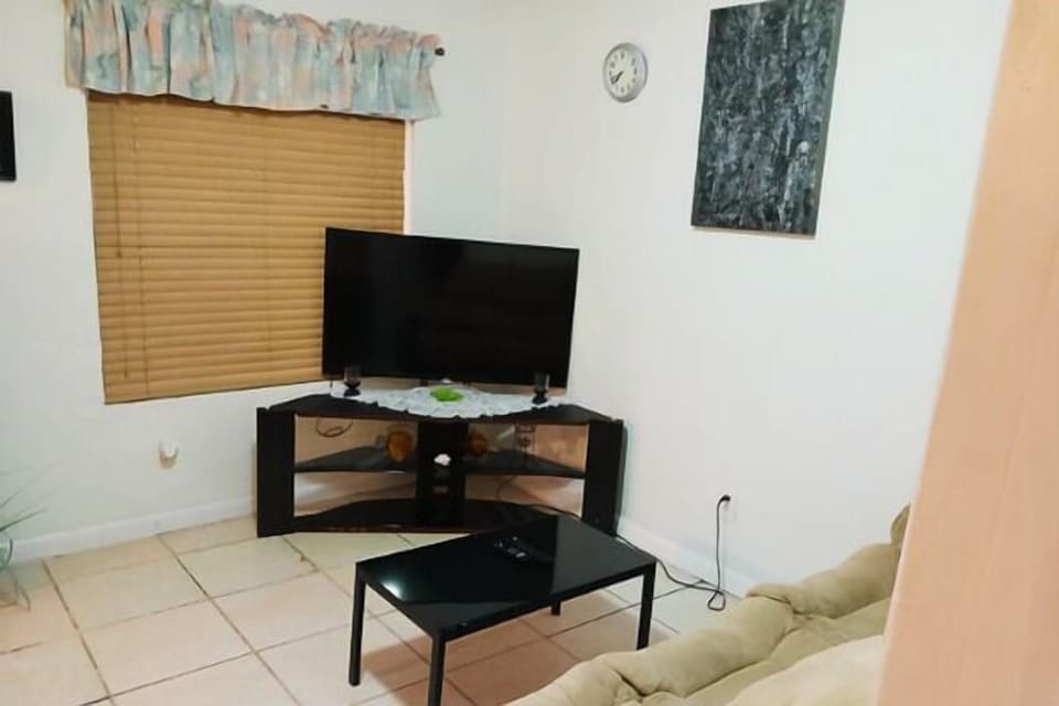 Inviting living space with flat-screen TV setup and comfortable seating.