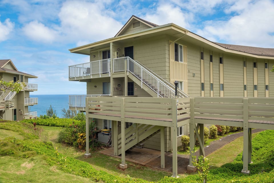 Home for the week: the top-floor corner, lifted above the bluff with the ocean behind it.