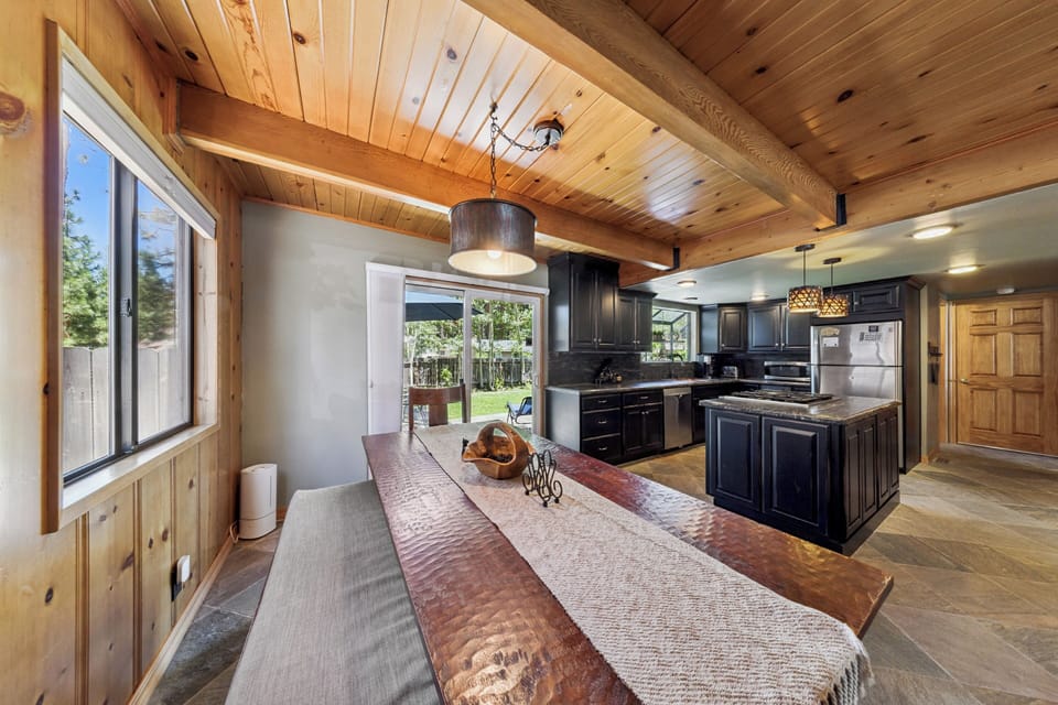 Step into this spacious open-concept kitchen and dining area, where rustic wood beams and modern finishes create the perfect blend of warmth and style. Natural light pours through large windows, inviting you to gather, cook, and relax in comfort.