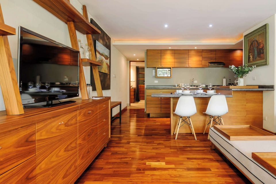 Bright open-plan space combining the living room and kitchen, with stylish wood cabinetry and modern finishes.