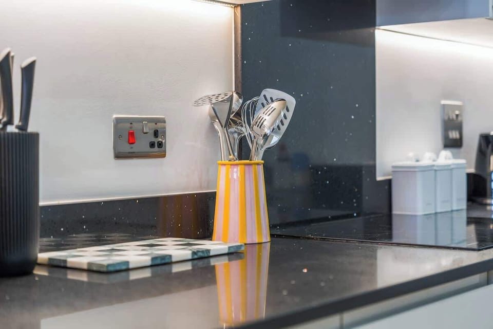 A closer look at the kitchen's luxury finishes, including polished stone counters and ambient task lighting.