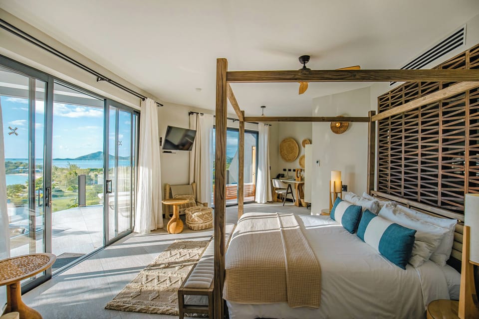 Wake slowly to sea breezes through expansive sliding glass doors.
