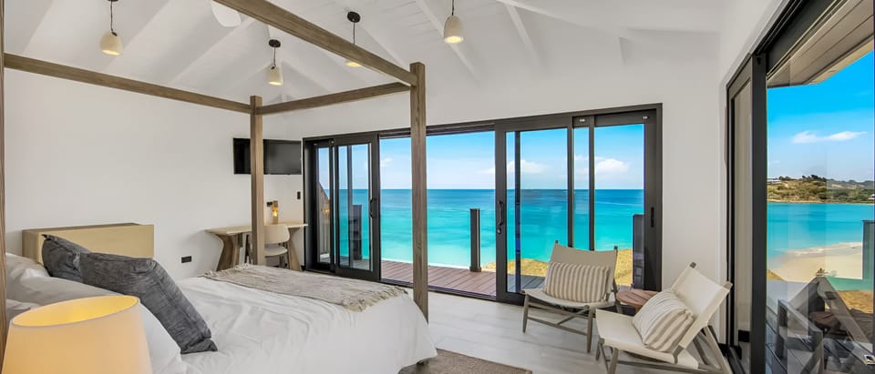 Wake up to breathtaking ocean views from your canopy bed.