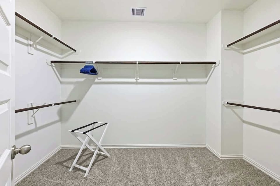 Spacious walk-in closet with plenty of storage.