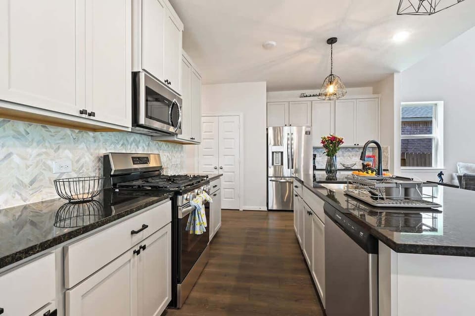 Modern kitchen with stainless steel appliances.