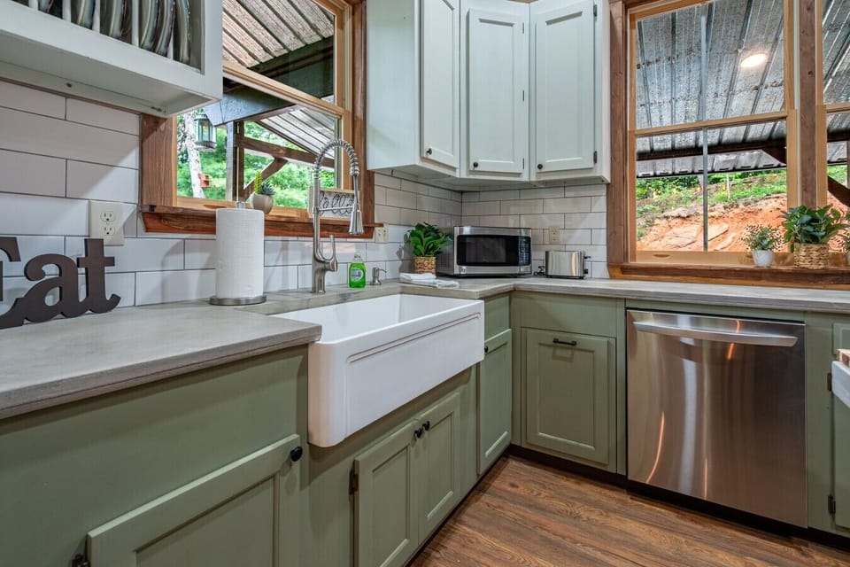 Enjoy preparing meals in the bright, fully equipped kitchen with farmhouse sink and peaceful woodland views.