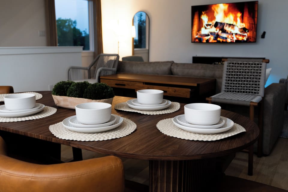 Cozy modern dining and living space with fireplace-style TV ambiance
