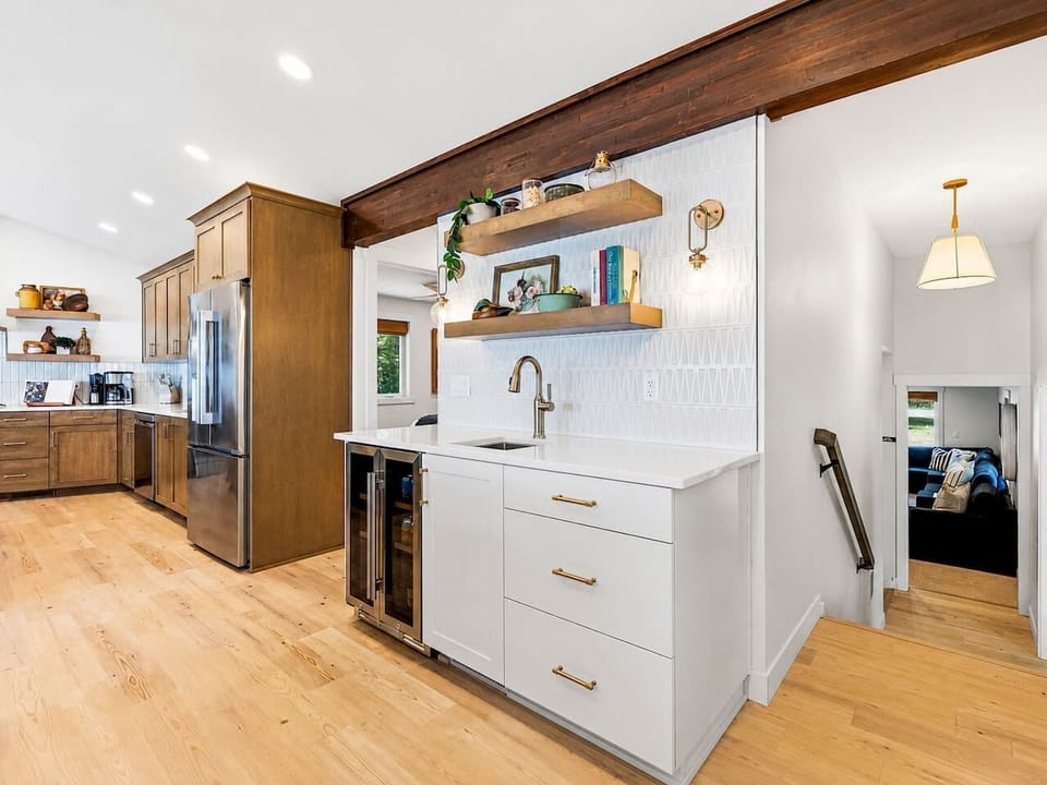 The kitchen wet bar adds a sink, beverage refrigerator, counter space, and storage for easy group entertaining.