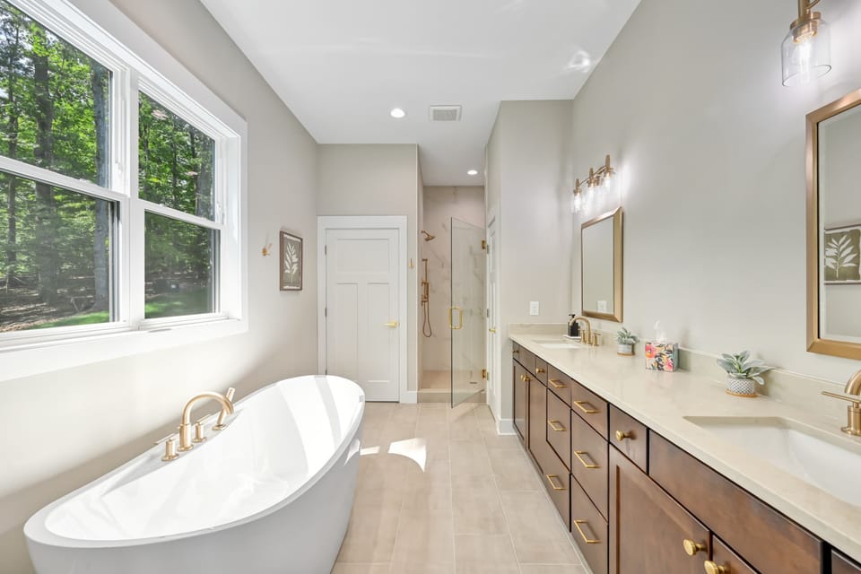 Sleek Spa Bathroom: Refresh in style with natural light, elegant fixtures, and a tranquil tub retreat!