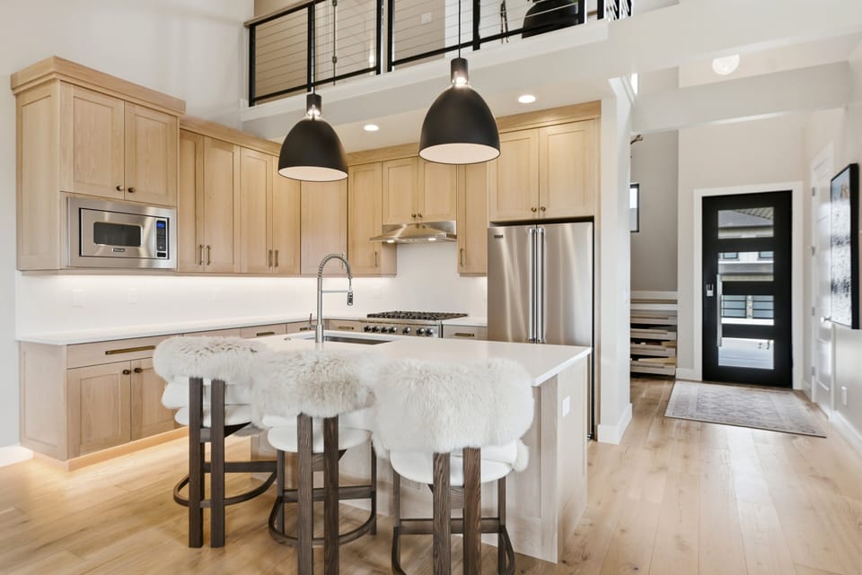 Bright gourmet kitchen at Keetley Vista featuring plush island seating, luxury finishes, and a welcoming open floor plan for gathering and entertaining.