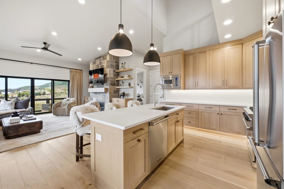 Gourmet kitchen at Keetley Vista featuring a spacious quartz island, premium appliances, custom cabinetry, and an open-concept layout.