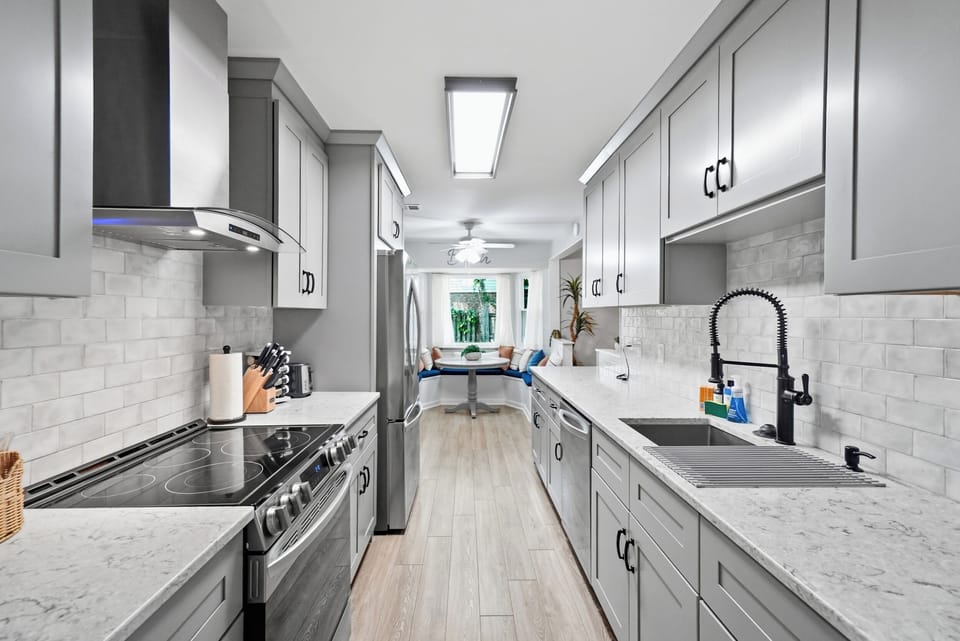 The renovated kitchen features stainless-steel appliances, generous counter space, and modern finishes.