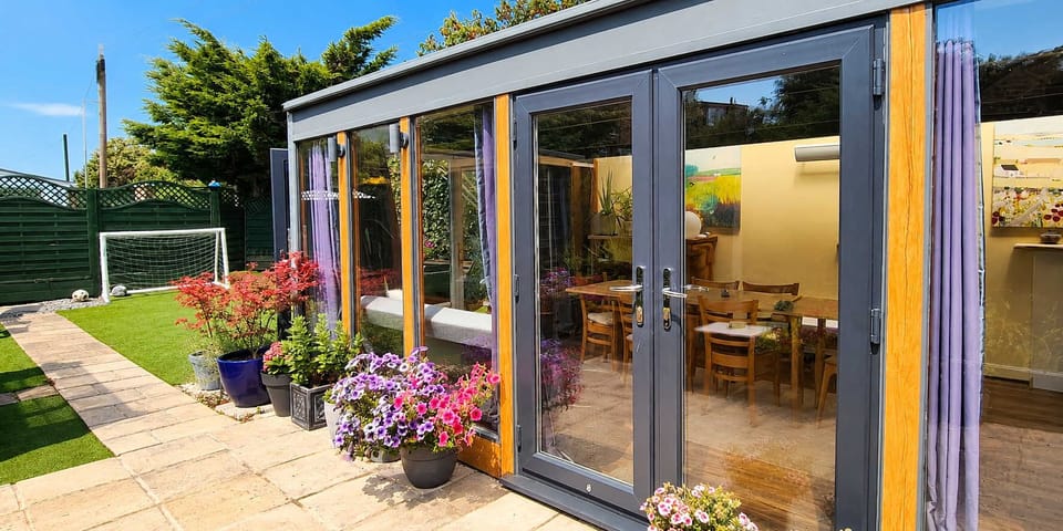 Seamless indoor-outdoor living surrounded by flowers and green garden space. ☀️🌸