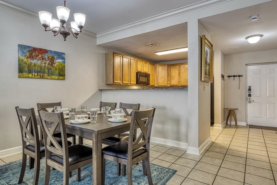 Wood cabinets, Kitchen. Dining room.  Place settings.  Nature art.  Cabinets.