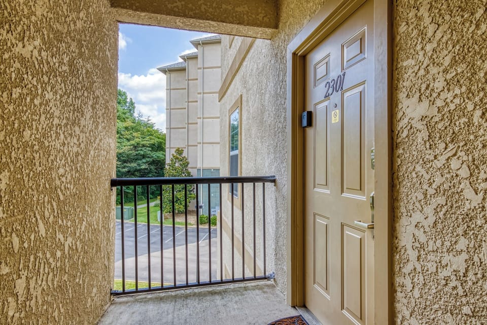 2301 exterior door, railing, parking lot, window. trees.