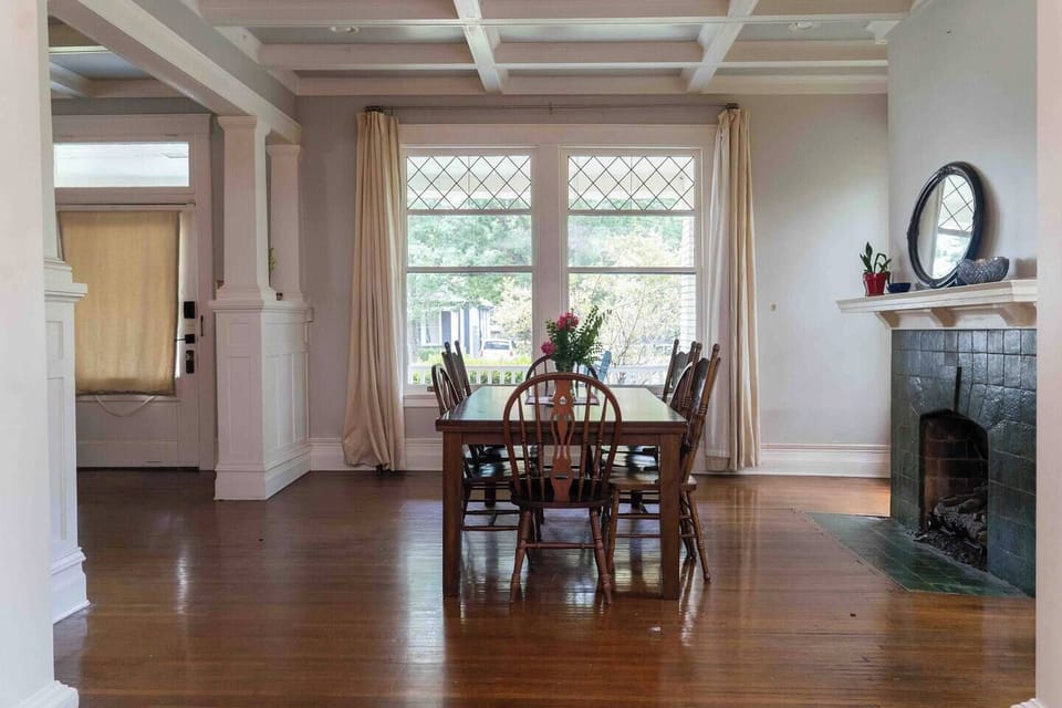 Dining room with diamond pane windows and warm oak floors