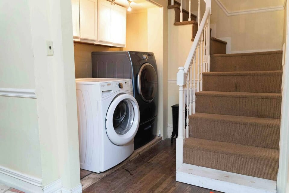 Full size washer and dryer on the ground floor beside the stairs
