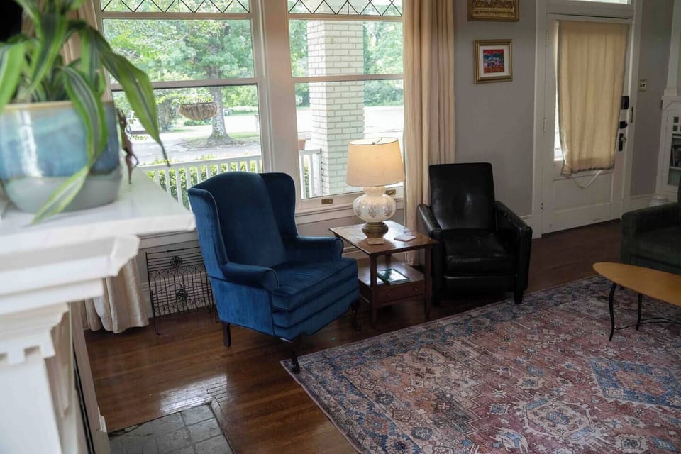 Pair of blue wingback chairs beside the window