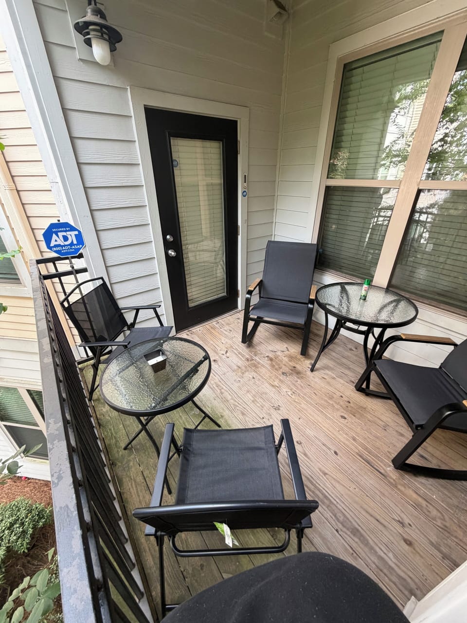 Private balcony with rocking chairs, dining for 4, gold bar cart & garden views