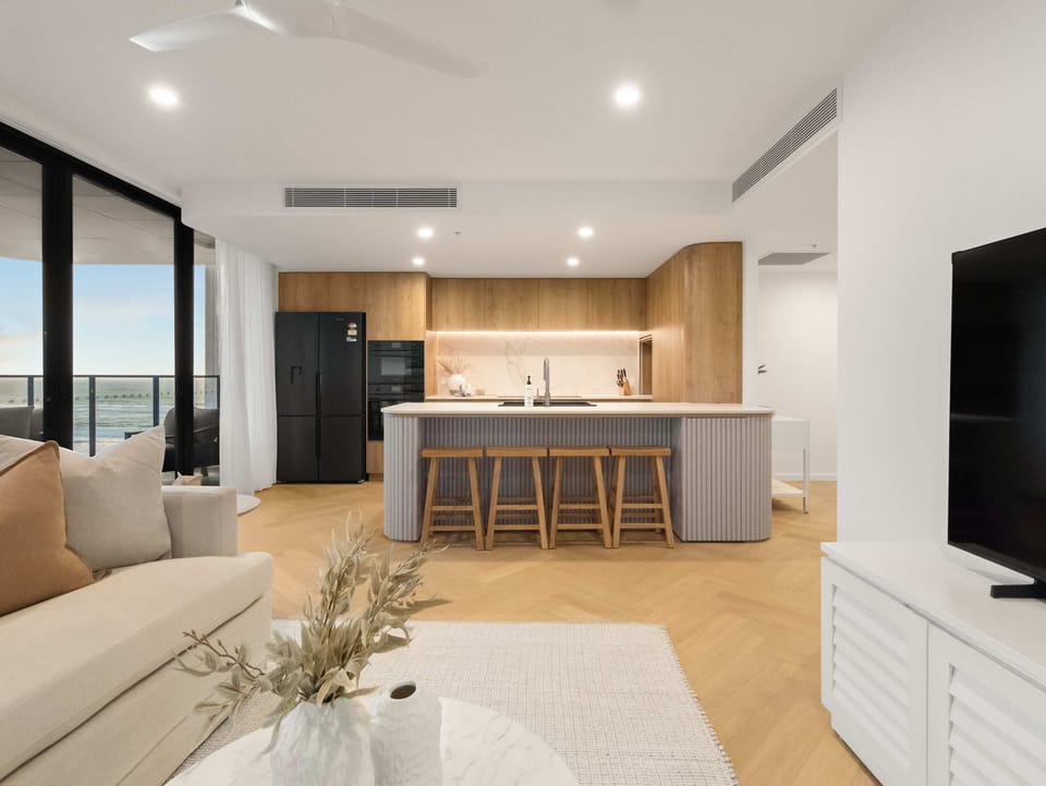 The living room reads straight through to the kitchen, so nobody is left out.