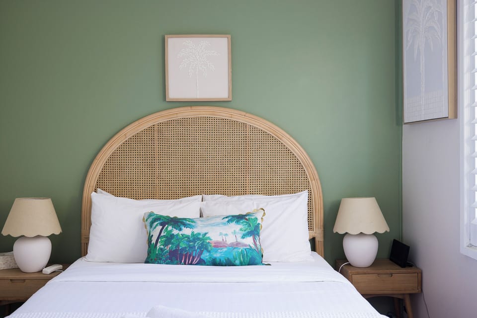 Serene bedroom with rattan headboard and fresh coastal-inspired style