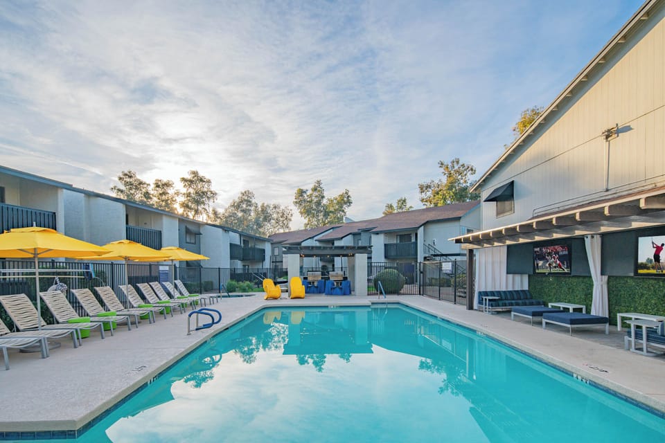 Take a dip in the inviting resort-style pool with lounge chairs and umbrellas   