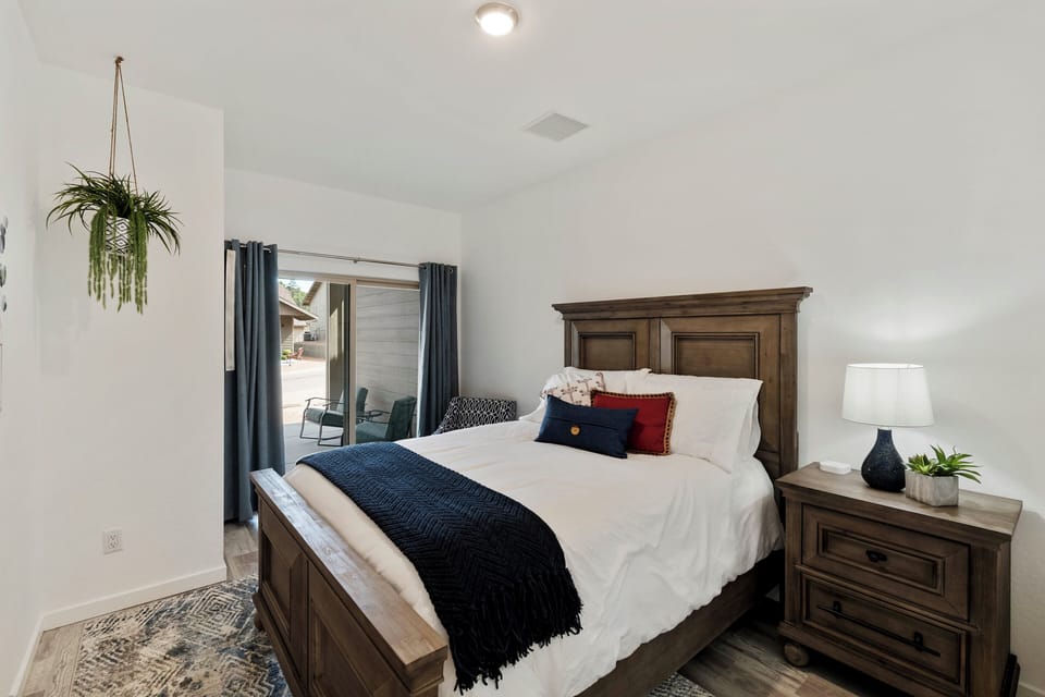 Bedroom 3  with queen bed and direct access to covered front patio. 