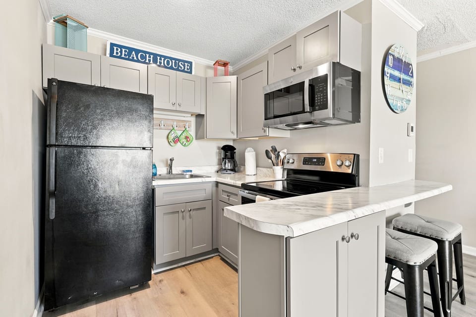 Prepare your favorite meals with ease in the fully stocked kitchen designed for convenient beachside living