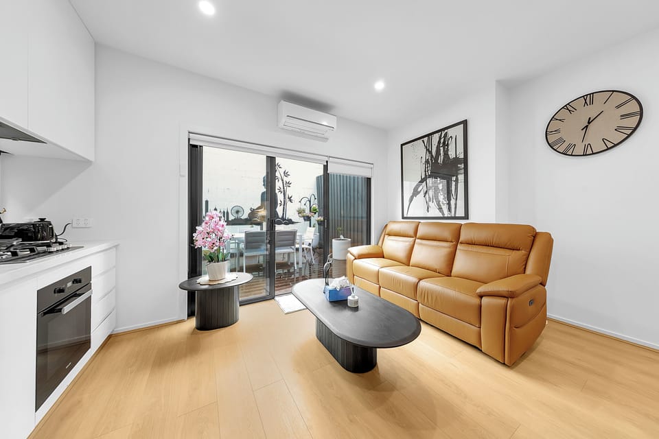 Bright modern lounge with AC, sleek kitchen, and private outdoor dining