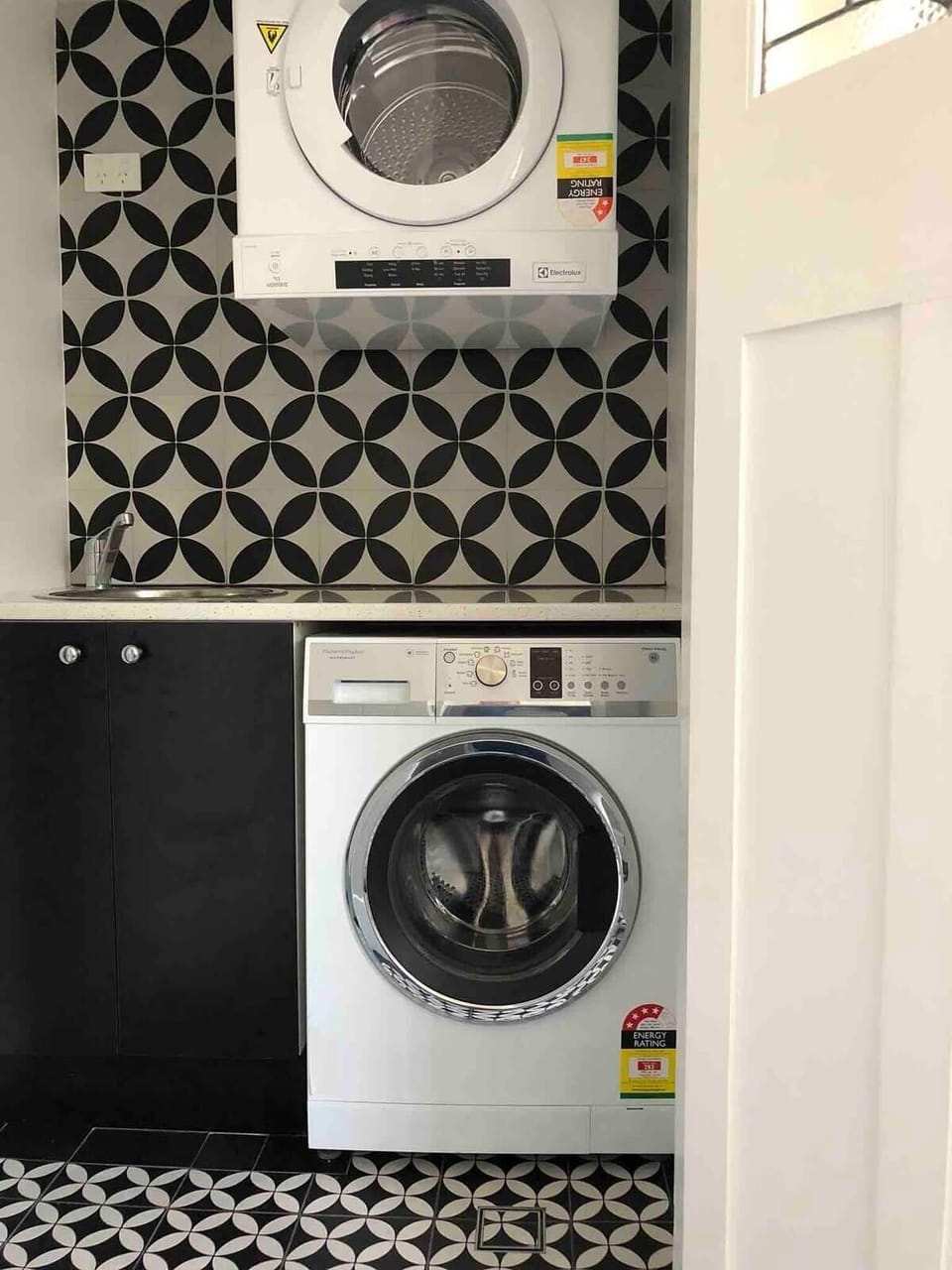 The laundry has a front load washer and dryer plus sink.
